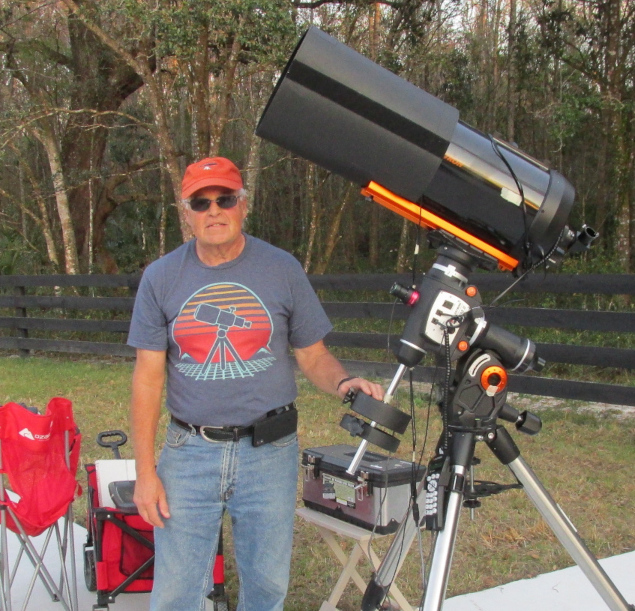 Member Ted Mitrou prepares to show the evening sky in his telescope.